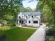 Stunning two-story modern farmhouse with lush front yard and a charming, covered porch at 3601 Woody Grove Ln, Charlotte, NC 28210