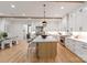 Bright and modern kitchen with stainless steel appliances, a large island, and white cabinets at 3601 Woody Grove Ln, Charlotte, NC 28210