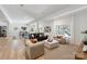 Spacious living room with hardwood floors, large windows, and ample seating at 3601 Woody Grove Ln, Charlotte, NC 28210