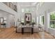 Bright living room with soaring ceilings, large windows, and a striking modern fireplace as its centerpiece at 3601 Woody Grove Ln, Charlotte, NC 28210