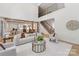 Spacious living room with an open-concept design, flowing into the modern kitchen and staircase at 3601 Woody Grove Ln, Charlotte, NC 28210