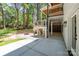 Covered outdoor patio with stone wall and ceiling with recessed lights at 3601 Woody Grove Ln, Charlotte, NC 28210