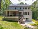 Spacious backyard featuring a covered patio, wooden deck, and a fire pit area at 3601 Woody Grove Ln, Charlotte, NC 28210