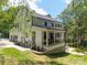 Back of house with a large deck, covered patio, and a lush, green yard at 3601 Woody Grove Ln, Charlotte, NC 28210