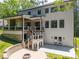 Large backyard with covered patio, second-story deck, and outdoor fire pit area at 3601 Woody Grove Ln, Charlotte, NC 28210