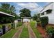 Backyard featuring a gated driveway, detached garage, and well-maintained lawn, creating a welcoming and functional outdoor space at 441 Jackson St, Rock Hill, SC 29730