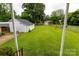 Expansive backyard featuring a lush lawn, a charming shed, and a classic chain-link fence, perfect for outdoor activities at 441 Jackson St, Rock Hill, SC 29730