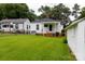 Backyard view featuring the main house, a detached garage, and a well-maintained lawn, creating a comfortable outdoor space at 441 Jackson St, Rock Hill, SC 29730