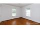 Bright, empty bedroom with hardwood floors and two windows with natural light at 441 Jackson St, Rock Hill, SC 29730