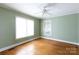 Bright bedroom with hardwood floors, two windows, neutral walls, and a ceiling fan at 441 Jackson St, Rock Hill, SC 29730