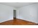 Empty bedroom with hardwood floors, white walls, and two white doors at 441 Jackson St, Rock Hill, SC 29730