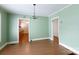 Spacious dining room featuring wood floors and views into the kitchen at 441 Jackson St, Rock Hill, SC 29730