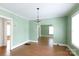 Dining room featuring wood floors, chandelier, and open layout at 441 Jackson St, Rock Hill, SC 29730