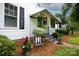 Inviting covered porch with wrought iron railings, adorned with plants and stylish decor at 441 Jackson St, Rock Hill, SC 29730