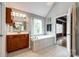 Bright bathroom with soaking tub, large window, and modern fixtures offers a relaxing retreat at 4712 Amberside Dr, Rock Hill, SC 29732
