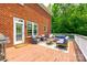 Outdoor deck featuring a seating area, grill, and door leading into the brick house at 4712 Amberside Dr, Rock Hill, SC 29732