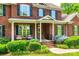 Charming front entrance featuring brick facade, covered porch, and manicured landscaping at 4712 Amberside Dr, Rock Hill, SC 29732