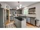 A modern kitchen with dark cabinets, stainless steel appliances, black granite countertops, and a central island at 4712 Amberside Dr, Rock Hill, SC 29732