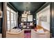 Elegant living room featuring dark walls, light trim, large windows, hardwood floors, and stylish furnishings at 4712 Amberside Dr, Rock Hill, SC 29732