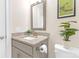 Updated bathroom with granite countertop vanity and a stylish mirror at 5060 Harrowsmith Ln, Charlotte, NC 28204