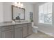 Well-lit bathroom with granite counters, gray vanity, decorative mirror, and plantation shutters at 5060 Harrowsmith Ln, Charlotte, NC 28204