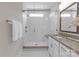 This updated bathroom is equipped with a large walk-in shower, sleek fixtures, and a modern vanity at 5060 Harrowsmith Ln, Charlotte, NC 28204