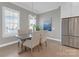 Cozy dining room with natural light, table and chairs, and stainless steel refrigerator at 5060 Harrowsmith Ln, Charlotte, NC 28204