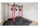 Bright exercise room with gym equipment and weights on a black padded floor at 5060 Harrowsmith Ln, Charlotte, NC 28204