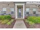 Charming brick townhome with a welcoming front door and beautiful landscaping at 5060 Harrowsmith Ln, Charlotte, NC 28204
