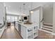 Spacious kitchen with island, open to the living room with hardwood floors throughout at 5060 Harrowsmith Ln, Charlotte, NC 28204
