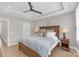 This gorgeous bedroom includes a ceiling fan, tray ceiling, recessed lights, and two bedside tables at 5060 Harrowsmith Ln, Charlotte, NC 28204