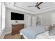 This beautiful bedroom includes a ceiling fan, tray ceiling, recessed lights, and a large dresser at 5060 Harrowsmith Ln, Charlotte, NC 28204