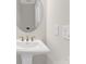 Pedestal sink powder room features an oval mirror and modern faucet at 5060 Harrowsmith Ln, Charlotte, NC 28204