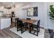 Stylish dining area with modern lighting fixtures, a wood table, and an adjacent kitchen at 512 Morrows Turnout Way, Pineville, NC 28134