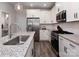 Stylish kitchen with stainless appliances, white cabinets, granite counters and modern fixtures at 512 Morrows Turnout Way, Pineville, NC 28134