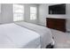 Cozy main bedroom with a large bed, dresser, and windows for natural light at 512 Morrows Turnout Way, Pineville, NC 28134