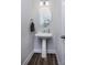 Quaint powder room with pedestal sink, modern lighting, and neutral decor at 512 Morrows Turnout Way, Pineville, NC 28134