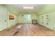 An unfinished attic space with light green walls, hardwood floors, and natural light from a window at 520 Eastwood Park Cir, Albemarle, NC 28001
