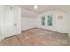 An attic room featuring hardwood floors, a window letting in natural light, and a minimalist aesthetic at 520 Eastwood Park Cir, Albemarle, NC 28001