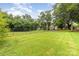 Wide-open backyard features manicured lawn, mature trees, and full perimeter fencing at 520 Eastwood Park Cir, Albemarle, NC 28001