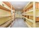 Unfinished basement with painted floor and wood shelving for storage in an older home at 520 Eastwood Park Cir, Albemarle, NC 28001