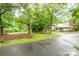 Charming home with a covered parking area and a circular driveway surrounded by mature trees at 520 Eastwood Park Cir, Albemarle, NC 28001