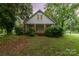 Charming two-story home with brick-columned front porch and lush landscaping at 520 Eastwood Park Cir, Albemarle, NC 28001