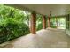 Spacious covered front porch with brick columns and a traditional hanging light fixture at 520 Eastwood Park Cir, Albemarle, NC 28001