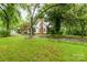 Charming home with a sprawling front yard, mature trees, and a brick chimney at 520 Eastwood Park Cir, Albemarle, NC 28001