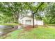 Detached white garage with side storage, offering ample space and functionality on a lush, green lot at 520 Eastwood Park Cir, Albemarle, NC 28001