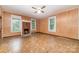 Living room with a brick fireplace and wood paneled walls with natural light at 520 Eastwood Park Cir, Albemarle, NC 28001