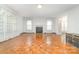 Bright living room with parquet floors, fireplace, and large windows at 520 Eastwood Park Cir, Albemarle, NC 28001
