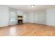 Cozy living room with hardwood floors and brick fireplace and large window with curtains at 520 Eastwood Park Cir, Albemarle, NC 28001