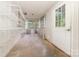 Bright sun room with white paneled walls, concrete floor, large windows, and a door to the exterior at 520 Eastwood Park Cir, Albemarle, NC 28001